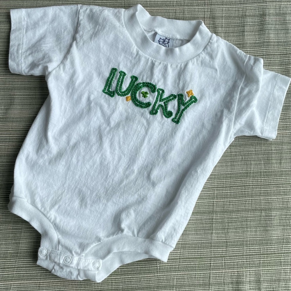 White Baby Onesie with Green 'Lucky' Embroidery
